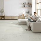 Woman reading in modern living room with allure terrazzo flooring