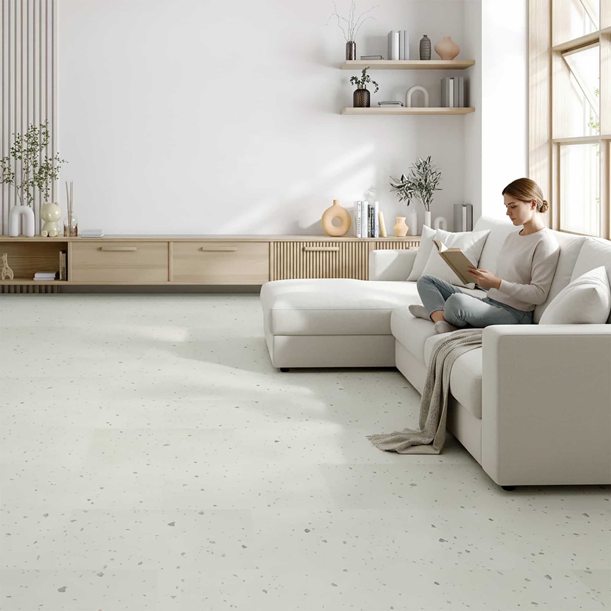Woman reading in modern living room with allure terrazzo tile flooring