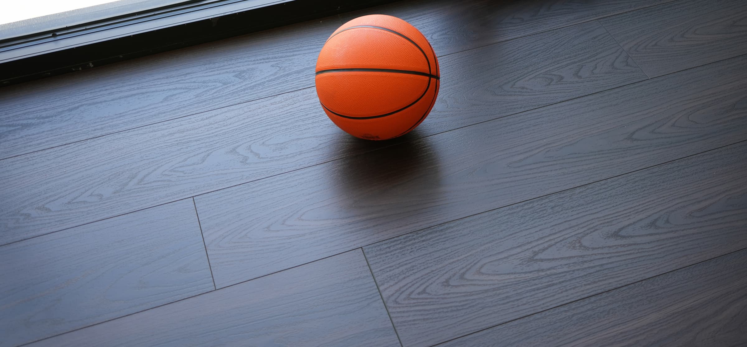 Basketball on top of Velvet Mocha luxury vinyl flooring by Allure