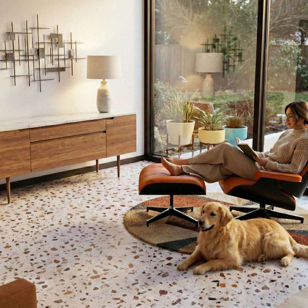 Woman sitting on a modern chair with a dog on a patterned rug in a stylish living room.