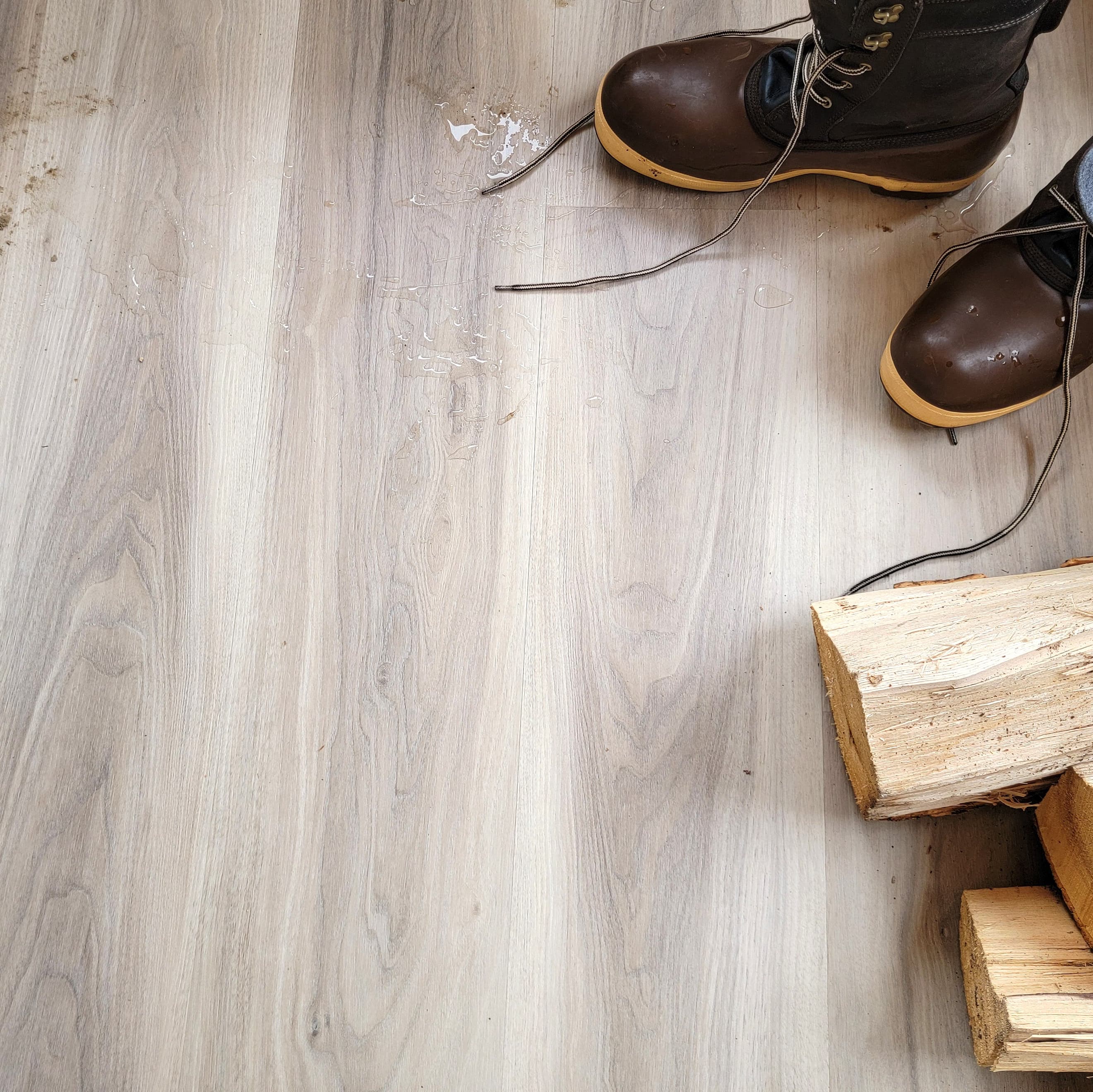 Allure Almond Honey Aspen Vinyl Planks with boots and pieces of fireowod