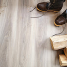 Allure Almond Honey Aspen Vinyl Planks with boots and pieces of fireowod